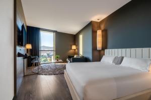 a hotel room with a large bed and a large window at Hotel SB Plaza Europa in Hospitalet de Llobregat +39 photos