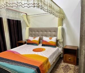 a bedroom with a bed with a canopy at KiGALI CITY COMFORT ACCOMMODATION in Kigali