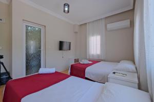 a bedroom with two beds and a window at Otel DENİZYILDIZI CENTRUM in Fethiye