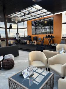 a lobby with a table and chairs and a stage at Borelie Guest House in Douala