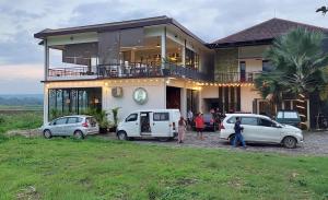 a house with three cars parked in front of it at Oemah Djari Hotel Syariah Salatiga in Salatiga