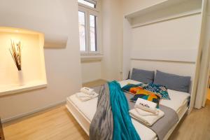 a bedroom with a bed with towels on it at Penelope's House in Otranto in Otranto