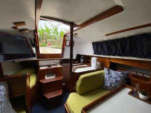 a small room with a couch and a tv in it at Ascot Bush Lodge & Spa in Pietermaritzburg