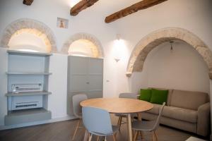 a living room with a table and a couch at Trullo Fico d'India in Alberobello
