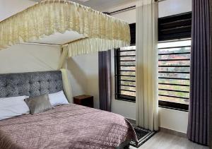 a bedroom with a bed with a canopy at KiGALI NORMAL VIEW APARTMENT in Kigali