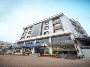 a large building with a store in front of it at Hotel The Avoir Asansol in Āsansol