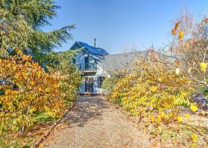 a large house with a pathway leading to it at River Verse in Porepunkah