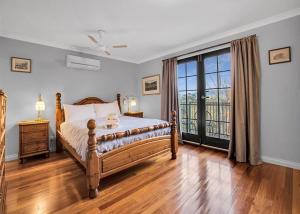 a bedroom with a bed and a large window at River Verse in Porepunkah