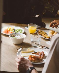 a table topped with plates of food and drinks at Honest Granada Hotel in Granada