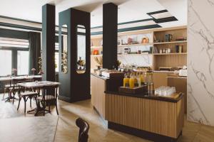 a restaurant with a bar and a dining room at Honest Granada Hotel in Granada
