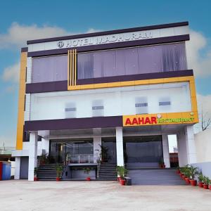 a building with an akhtar restaurant in front of it at Madhuram Hotel in Ayodhya