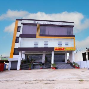 a building with an akari restaurant in front of it at Madhuram Hotel in Ayodhya