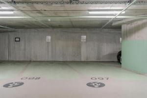 an empty parking garage with a car parked in it at Mona Luxury Apartments - Free Garage Parking in Sarajevo