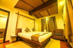 a hotel room with a bed and a window at Hotel Sepoy Grande in Mysore