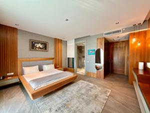 a bedroom with a bed and a bathroom at Arts Hotel Bodrum Yalikavak in Yalıkavak