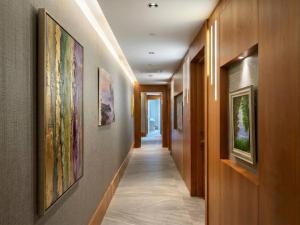 a hallway with paintings on the walls at Arts Hotel Bodrum Yalikavak in Yalıkavak