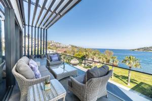 a balcony with a view of the ocean at Arts Hotel Bodrum Yalikavak in Yalıkavak