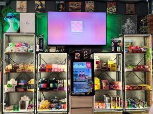 a shop with a computer screen in a store at Holy Hostel Sathorn in Thung Maha Mek