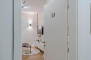 a room with white walls and a glass door at Mona Luxury Apartments - Free Garage Parking in Sarajevo +49 photos