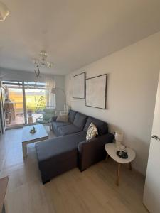 a living room with a blue couch and a table at El Rincón de Usgo in Miengo
