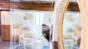 a mirror reflection of a room with a table and chairs at Rio Alba Blue, Terre Marine in Riomaggiore