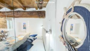 a room with a mirror and a bed in it at Rio Alba Blue, Terre Marine in Riomaggiore