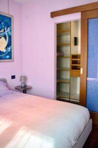 a bedroom with a bed and a book shelf at Tra le Alpi - Holiday House in Tresivio