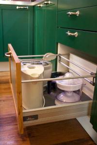 a toilet in a bathroom with a green cabinet at Tra le Alpi - Holiday House in Tresivio +57 photos