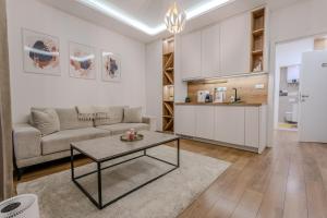 a living room with a couch and a table at Mona Luxury Apartments - Free Garage Parking in Sarajevo