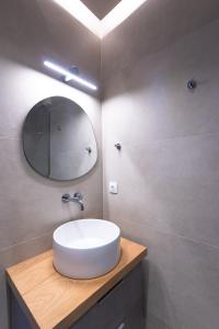 a bathroom with a white sink and a mirror at Island Suite, Old Town in Corfu +56 photos