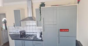 a kitchen with a stove and a sign that reads uichen at Parkside Studio in Luton