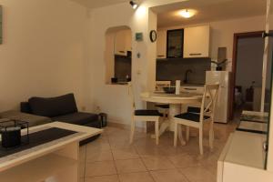 a living room with a couch and a table at Apartments Daidzic by El-Pi Tours in Njivice