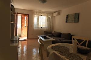 a living room with a couch and a table at Apartments Daidzic by El-Pi Tours in Njivice