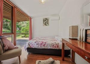 a bedroom with a bed and a desk and a window at Stonehaven in Freeburgh