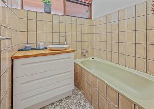 a bathroom with a sink and a bath tub at Stonehaven in Freeburgh +12 photos