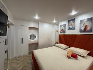 a bedroom with a bed and a flat screen tv at Korkyt in Qyzylorda