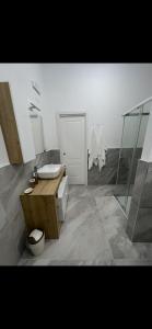 a bathroom with a sink and a toilet and a shower at MaVi Apartament in Castel di Sangro
