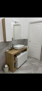 a bathroom with a sink and a mirror at MaVi Apartament in Castel di Sangro