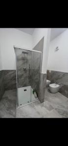 a bathroom with a glass shower and a toilet at MaVi Apartament in Castel di Sangro