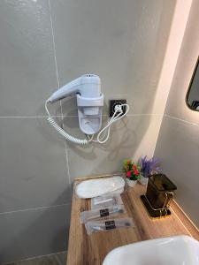a light on a wall next to a toilet at Korkyt in Qyzylorda