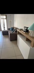 a living room with a couch and a table at MaVi Apartament in Castel di Sangro