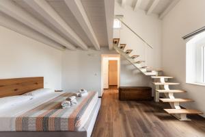 a bedroom with a bed and a staircase at Villa Meti in Avola +19 photos