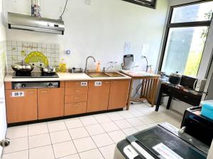a kitchen with a sink and a counter top at Horse Riding Next Door in Yuanshan