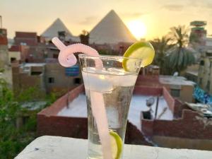 a drink on a table with a view of pyramids at Imperial Pyramids View Inn in Cairo