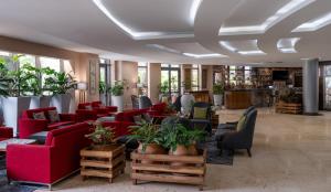 a lobby with red couches and plants at Radisson Blu Hotel Lusaka in Lusaka +268 photos