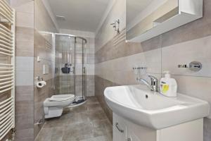 a bathroom with a sink and a toilet at Penzion Na Chalupě in Polička +20 photos
