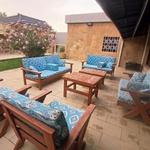 a patio with couches and chairs and a table at شاليهات وقت الفرح in Riyadh