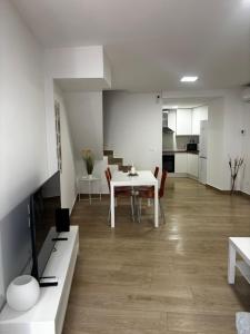 a living room with a white table and chairs at Casa Privada Benidorm Centro in Benidorm +10 photos