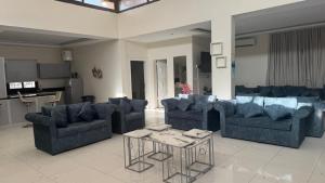 a living room with blue couches and a table at شاليهات وقت الفرح in Riyadh