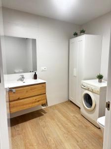 a bathroom with a sink and a washing machine at Casa Privada Benidorm Centro in Benidorm